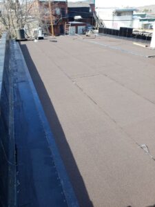 Silverback Torch On Systems Ltd. crew assessing the commercial flat roof deck prepped for new torch-on system installation