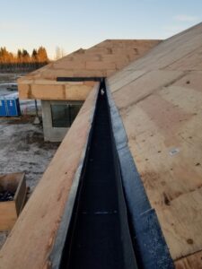 Silverback Torch On Systems Ltd. commercial roofers removing old flat roof layers in preparation for new torch-on membrane system